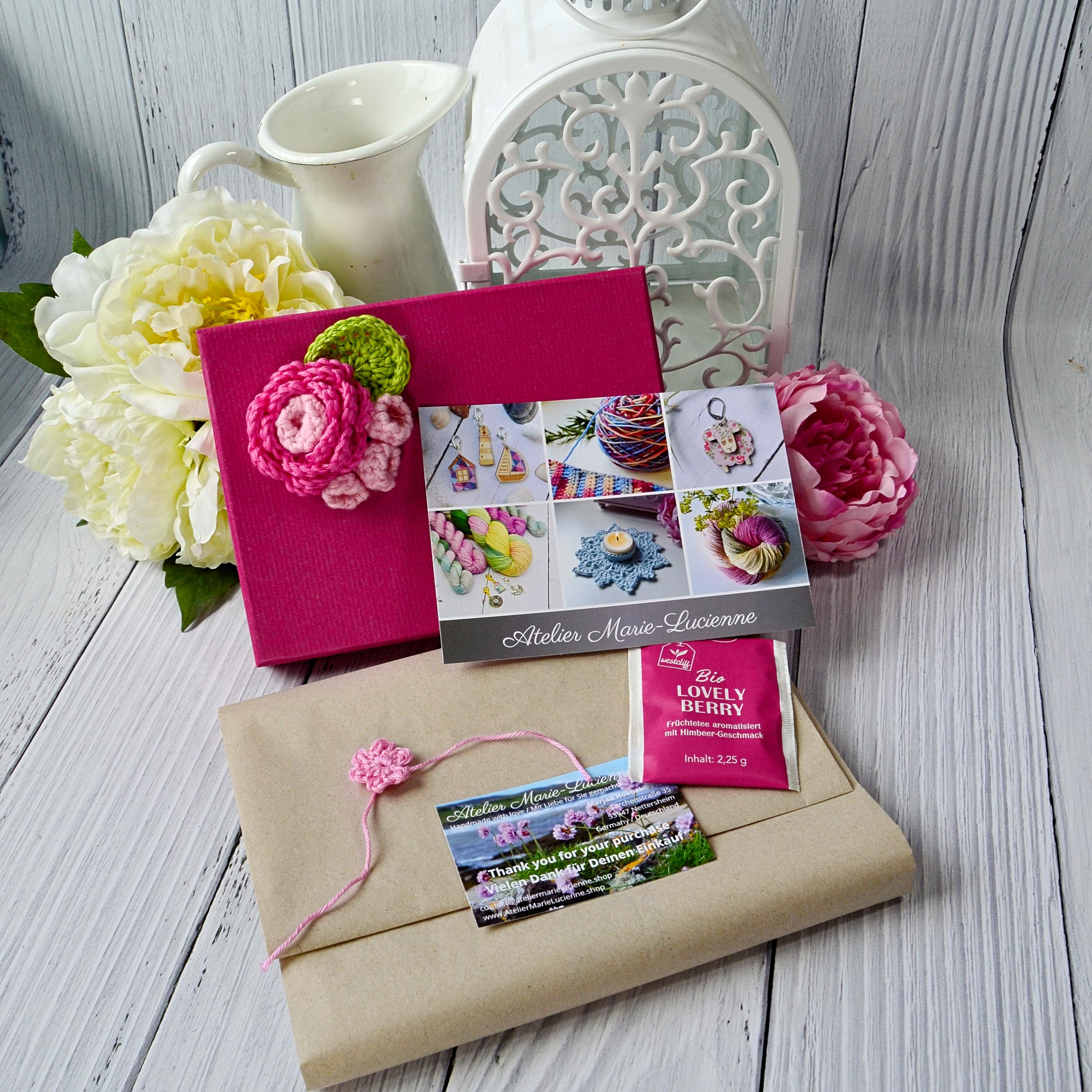 Welcome gift pack in pink with contents not yet unwrapped in front of it